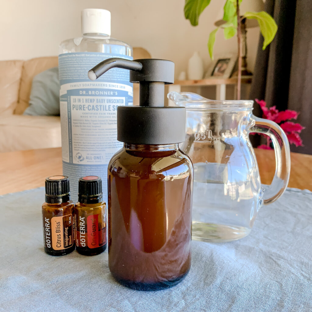 Organic and natural ingredients for DIY natural foaming hand soap recipe laid out. Doterra Oils. Country home and country blue linen napkin. 