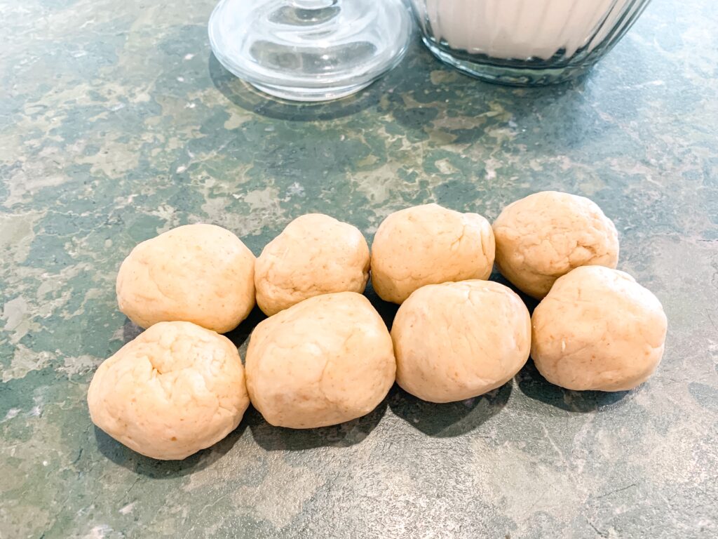 8 little balls of dough ready to roll