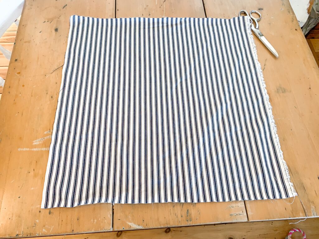 mattress ticking fabric laid out on sewing table